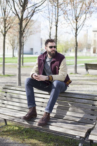 Woman sitting on bench in park