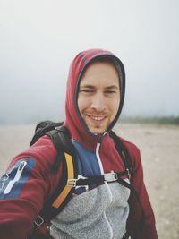 Portrait of smiling young man against blurred background