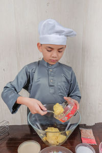 Boy preparing food in kitchen