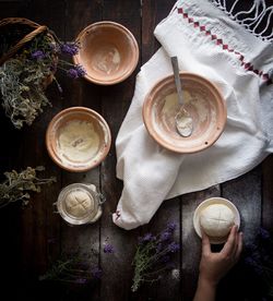 High angle view of hand holding tea cup on table