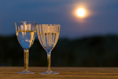 Glasses of white wine in moonlight