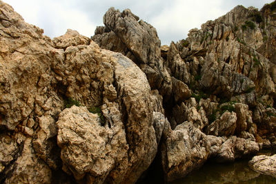 Close-up of rock formation against sky