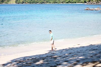 Full length of woman standing on beach