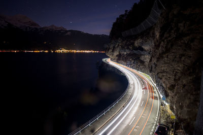 High angle view of light trails on road against sky at night