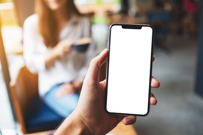 Midsection of woman using mobile phone