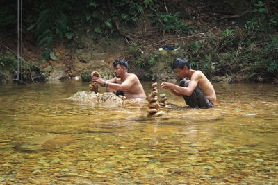 Side view of two men in the river