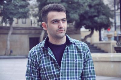 Portrait of young man standing outdoors