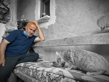 Man sitting by wall