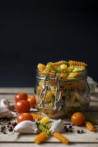 Close-up of fruits on table against black background