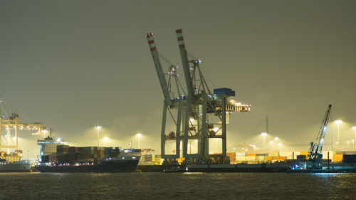 Cranes at commercial dock at night