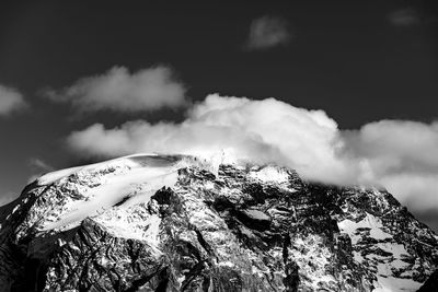 Scenic view of snow covered mountains against sky