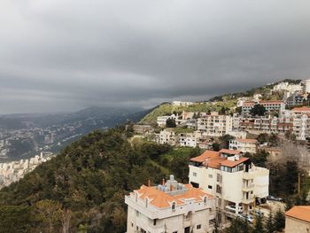 High angle view of buildings in town against sky