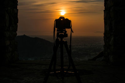 View of camera against sky during sunset
