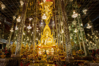 Low angle view of statue against illuminated building