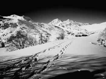 Scenic view of snow covered mountains against sky