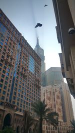 Low angle view of clock tower in city against sky