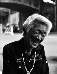 Cheerful senior woman in city