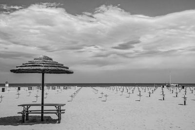 Lifeguard hut on beach against sky