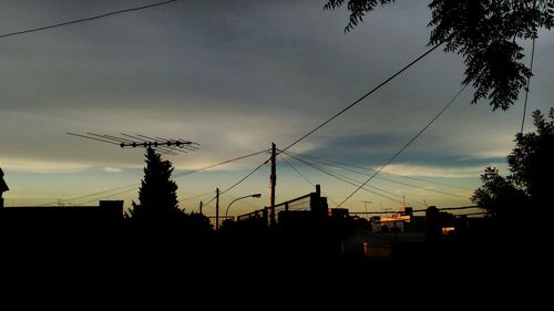 Low angle view of electricity pylon against sky