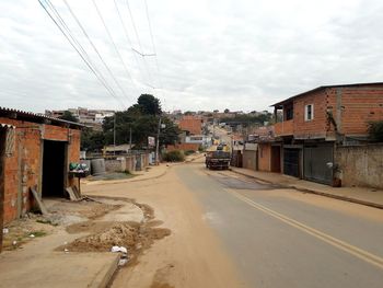 Street amidst buildings in city against sky