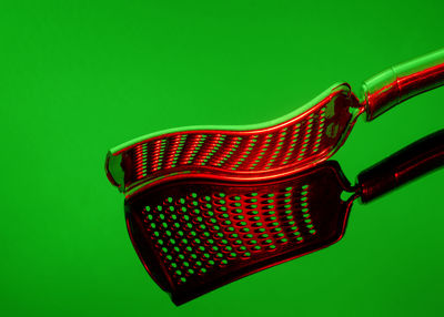 Close-up of cooking utensils over green background