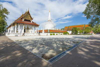 Temple by building against sky