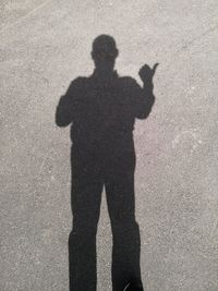 Shadow of man on road