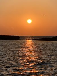Scenic view of sea against romantic sky at sunset