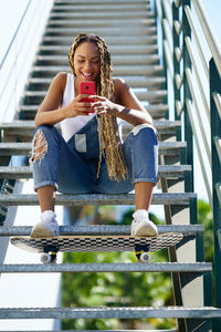 Portrait of young woman using mobile phone