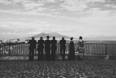 Tourists standing an observation point looking at a view