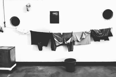 Clothes drying on table against wall at home