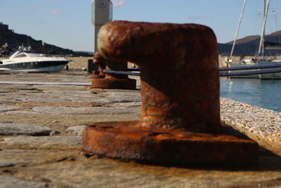 Close-up of wood on beach against sky