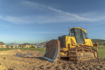 Construction site on beach against sky