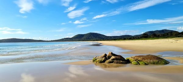 Scenic view of sea and mountains against sky