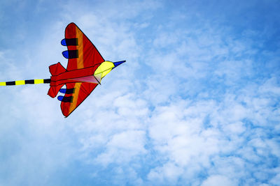 Low angle view of kite flying against blue sky