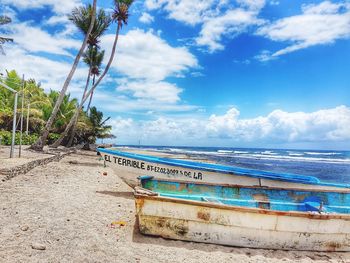 Scenic view of beach against blue sky