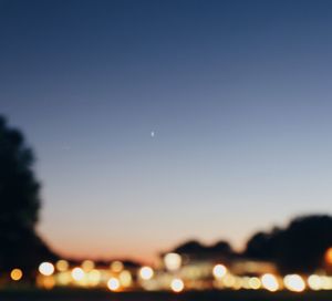 Defocused image of moon against sky at night