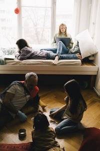 Family playing in living room at home