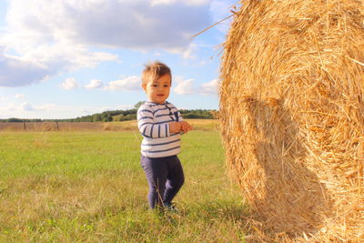 Full length of boy standing on field