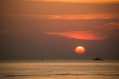 Scenic view of sea against orange sky