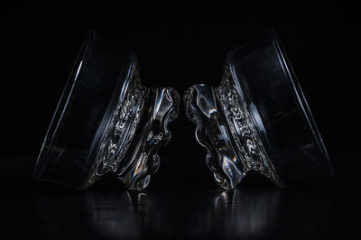 Close-up of glass bowls against black background