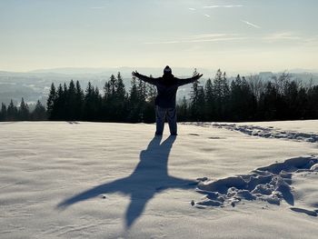 Full length of person standing on snow covered land