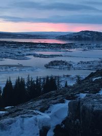 Scenic view of snow covered landscape against cloudy sky