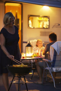 Family having barbecue at night