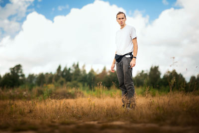 Full length of man standing on field against sky