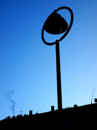 Low angle view of street light against blue sky