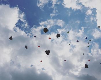 Low angle view of balloons against sky