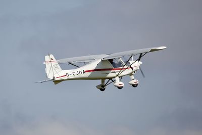 Low angle view of airplane flying against sky
