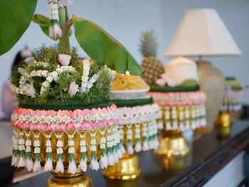 Close-up of potted plant on table against building