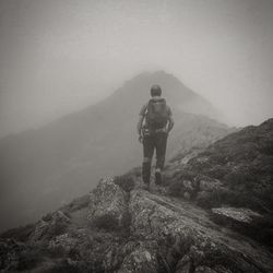 Rear view of man standing on mountain